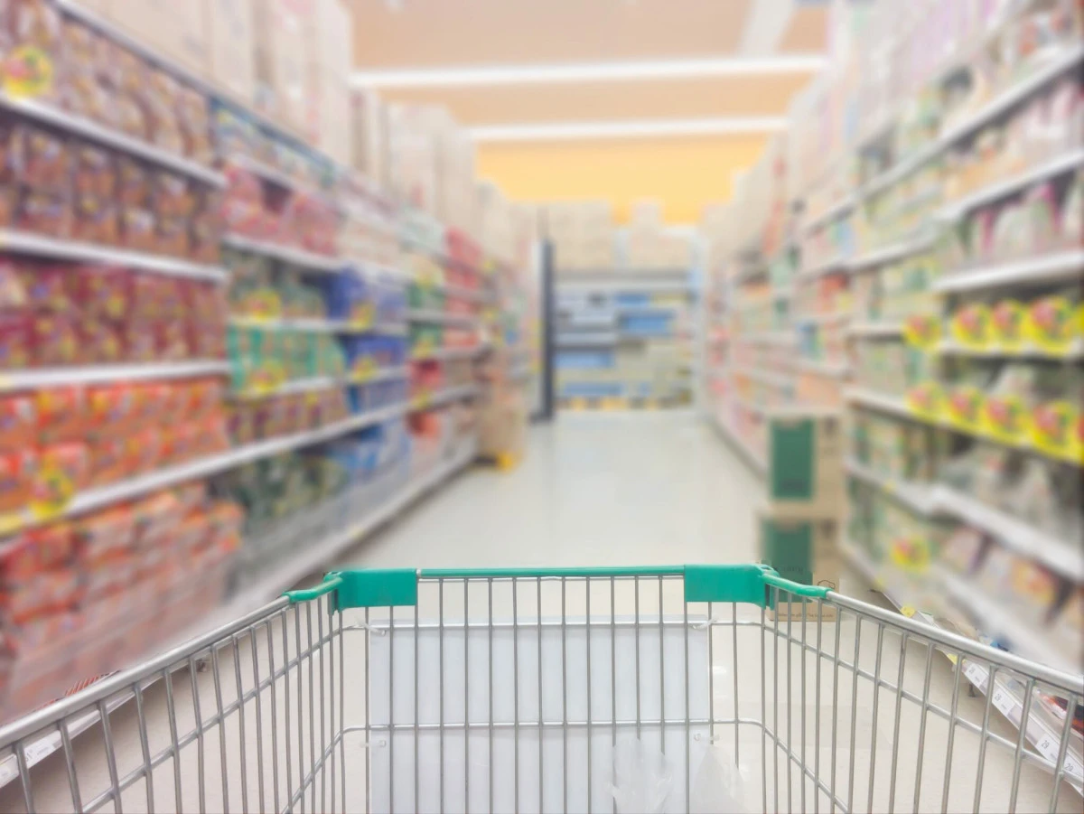 Shopping cart in a grocery store aisle