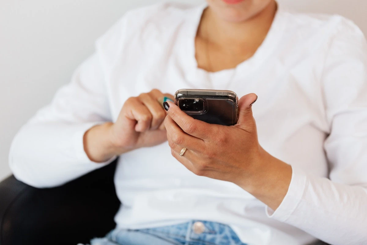 A person looking at a text message from a marketing channel